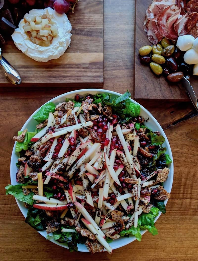 Apple, pomegranate, candied pecan and red leaf lettuce salad with toasted mustard seed-apple vinaigrette.