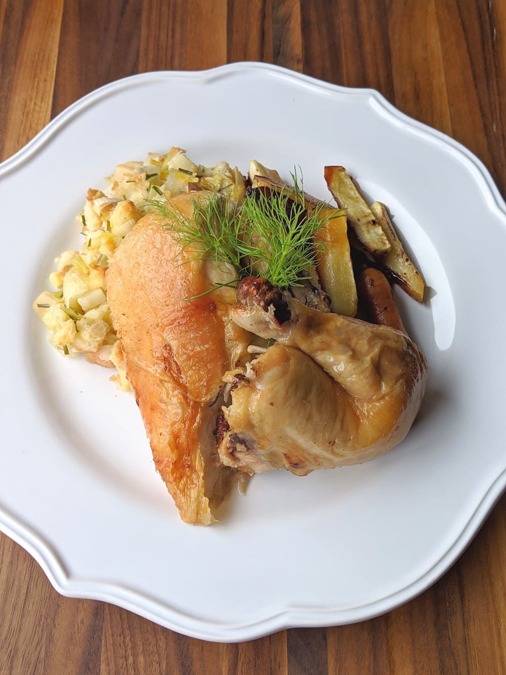 Cornish Hen, Apple Stuffing, Roasted Root Veggies Plate with breast and leg of Cornish hen, apple fennel stuffing and roasted carrots and parsnips.